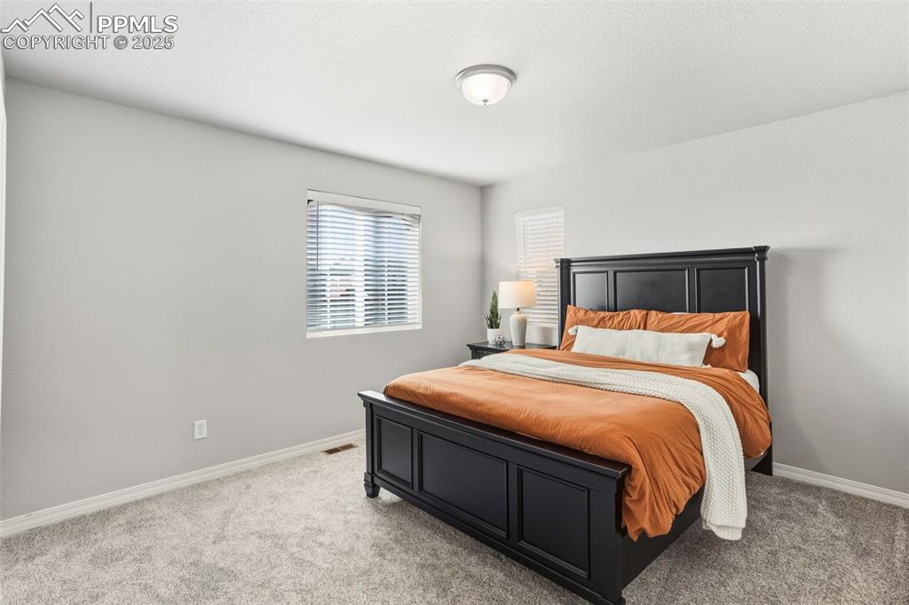 Image 25 of 37: Bedroom featuring light colored carpet