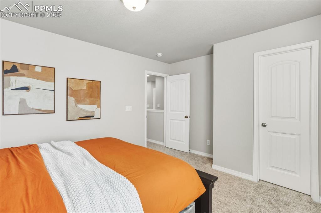 Image 26 of 37: Bedroom featuring baseboards and light carpet