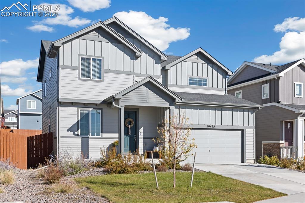 Image 3 of 37: View of front of property featuring board and batten siding, driveway, and