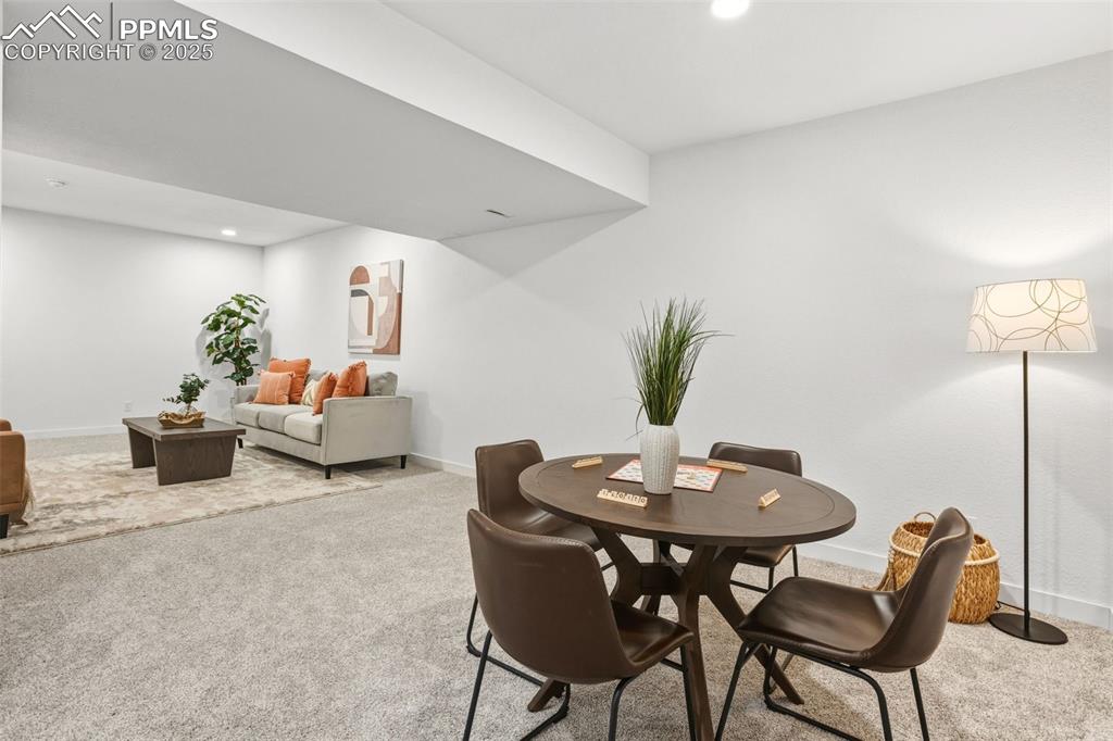 Image 30 of 37: Dining area with light carpet and recessed lighting