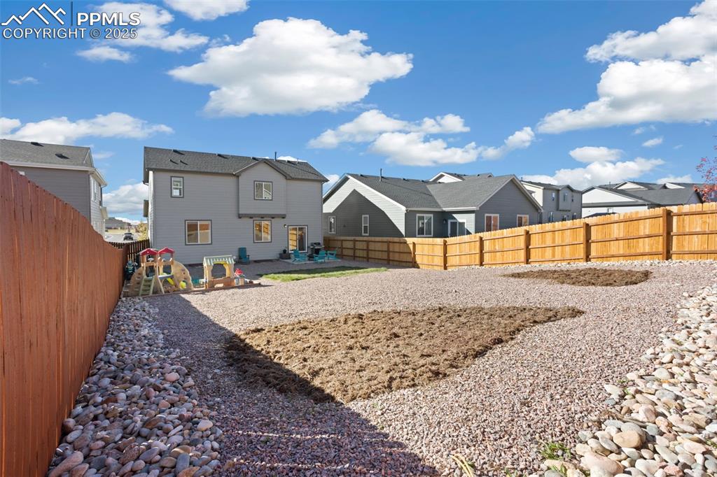 Image 37 of 37: Rear view of house featuring a fenced backyard, a residential view, a patio