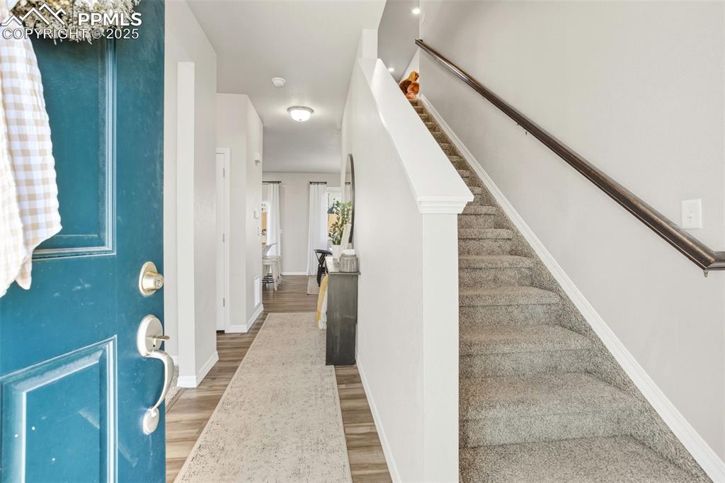 Image 5 of 37: Entryway with light wood finished floors and stairs