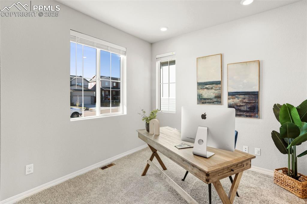 Image 7 of 37: Office with light colored carpet and recessed lighting