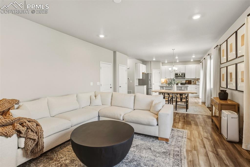 Image 8 of 37: Living room featuring recessed lighting and light wood finished floors