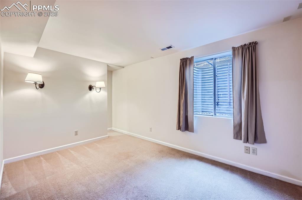 Image 23 of 28: Carpeted bedroom with baseboards