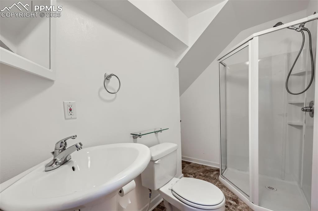 Image 24 of 28: 3/4 bathroom featuring a sink and a shower stall