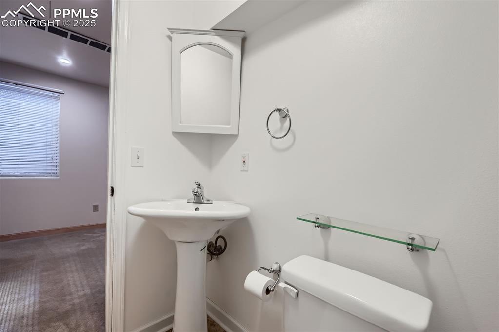 Image 25 of 28: 3/4 bathroom with toilet and baseboards
