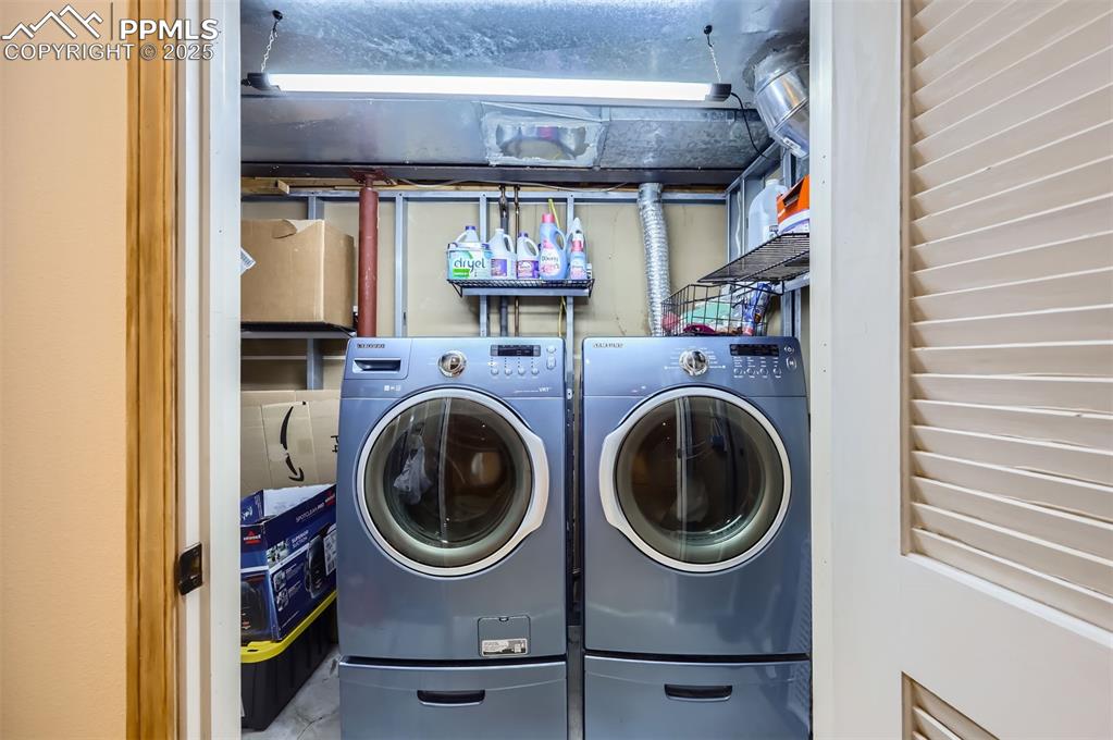 Image 26 of 28: Laundry room with separate washer and dryer