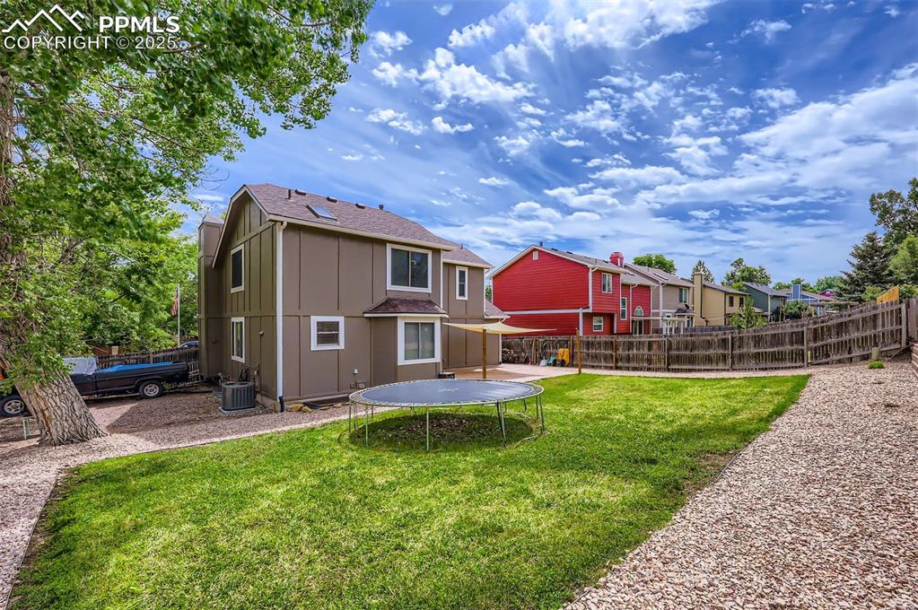 Image 27 of 28: Back of house with a double gate for small RV, boat, or car storage