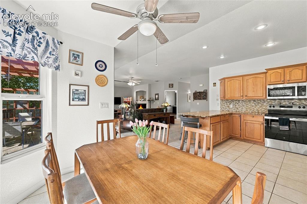 Image 10 of 36: Kitchen featuring wood cabinetry, granite countertops, pantry