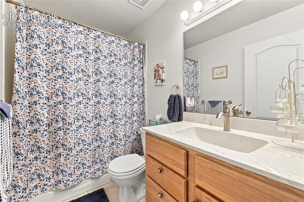 Image 19 of 36: Vanity with an integrated sink, brushed nickel faucet, and wood-finish cabi