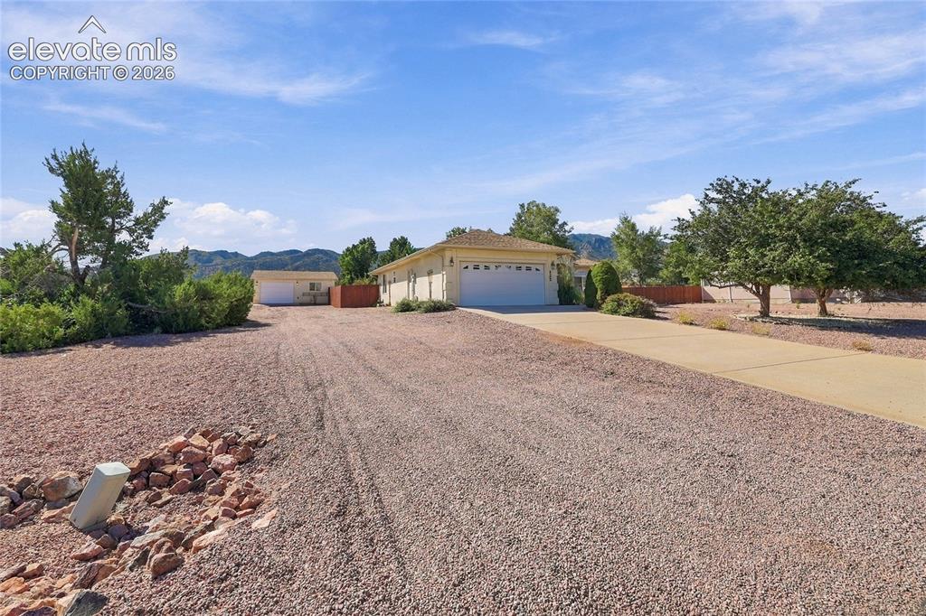 Image 28 of 36: Ranch-style residence featuring an attached two-car garage, an additional d