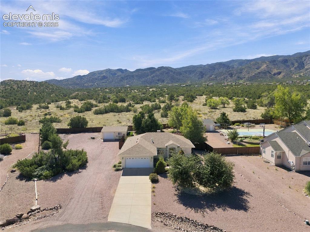 Image 3 of 36: Expansive property with a concrete driveway, attached garage, and a separat