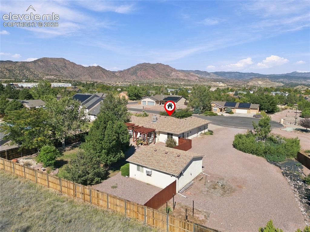 Image 35 of 36: Expansive property featuring a detached garage, a full privacy fence, and a