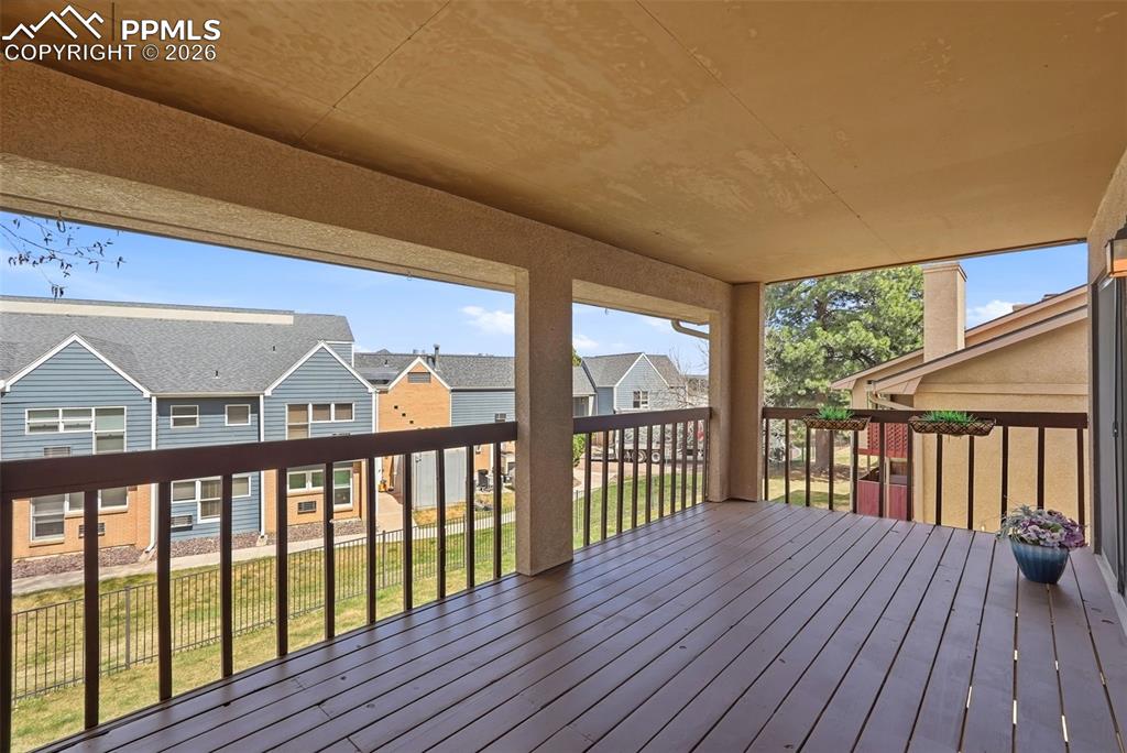 Image 11 of 44: The property features an expansive outdoor balcony with a dark wood deck, a