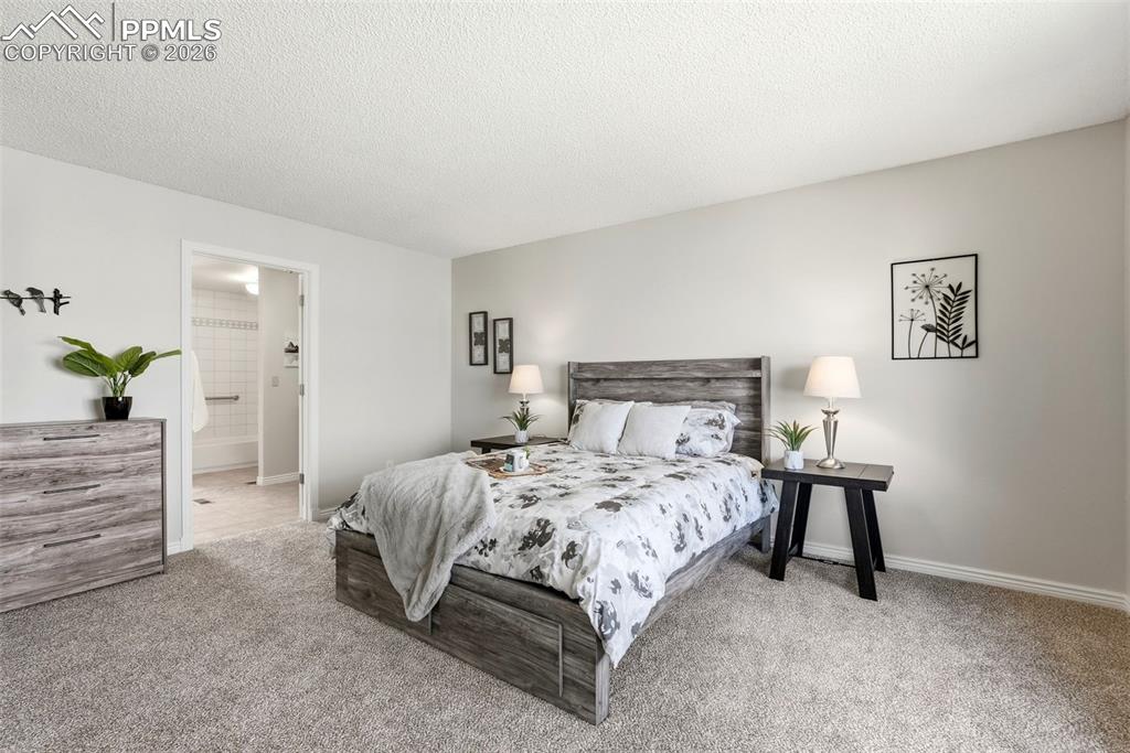 Image 17 of 44: This room features light-colored walls and grey carpet flooring