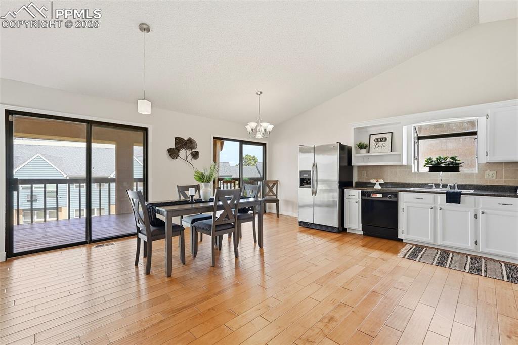 Image 2 of 44: Open concept living space featuring hardwood floors, a kitchen with white c