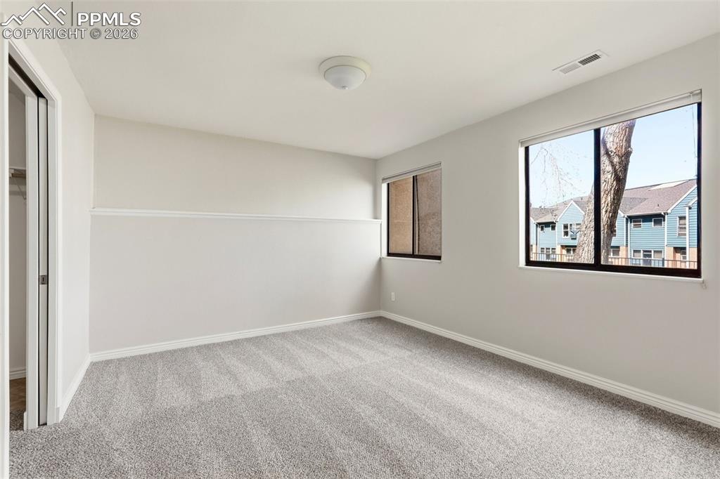 Image 31 of 44: This room features light gray walls with a decorative molding, gray carpet,