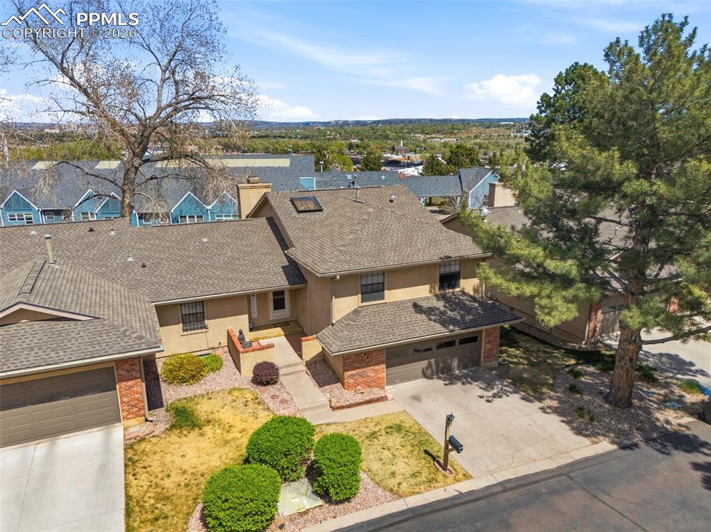 Image 37 of 44: The property features a multi-level design with an attached garage and a co