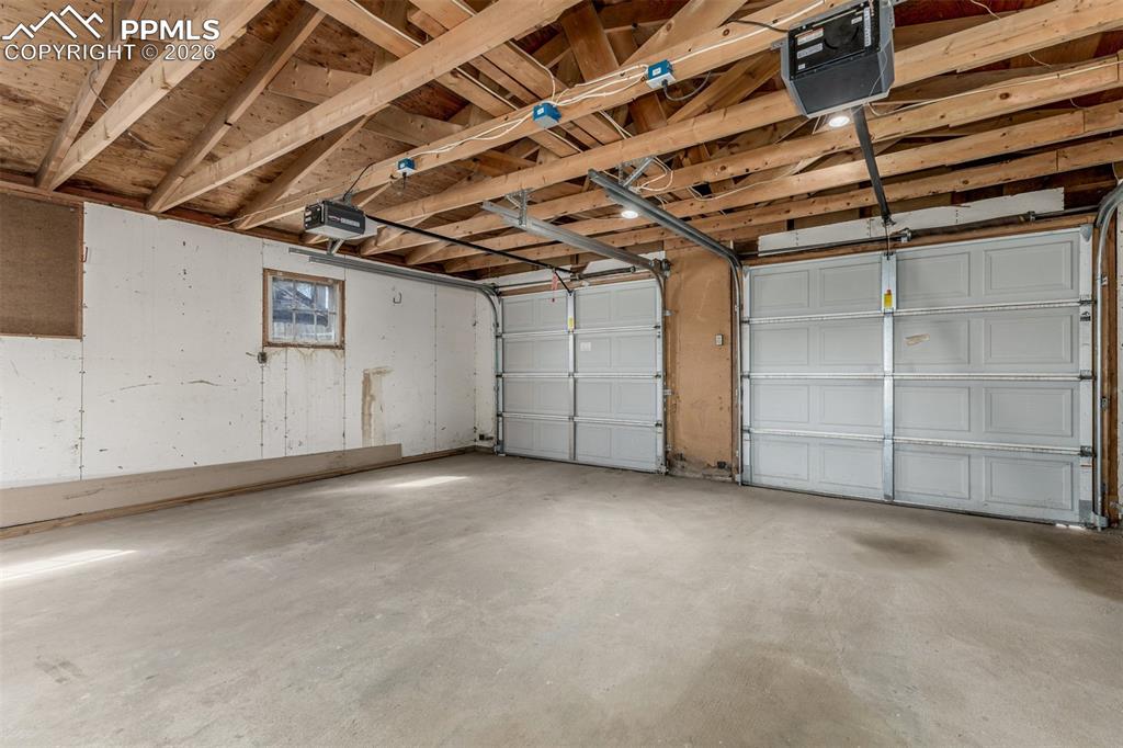 Image 24 of 40: Garage with a garage door opener