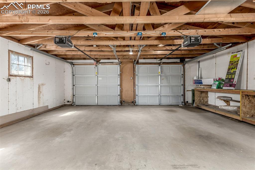 Image 25 of 40: Garage with a garage door opener