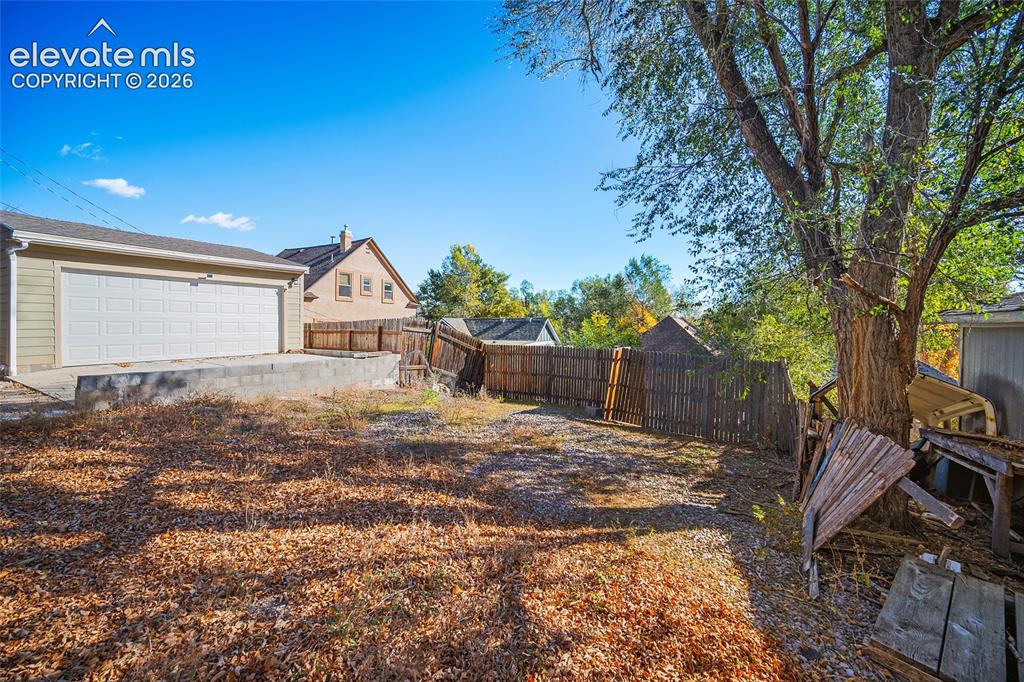Image 26 of 35: Parking spaces behind home. (Garage is neighbors garage)