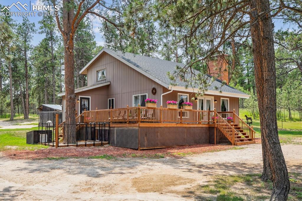 Image 23 of 29: Front of home featuring wraparound deck
