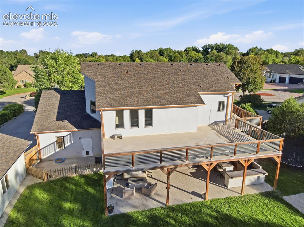 Image 43 of 49: Expansive outdoor living space featuring a multi-level deck with wood and m