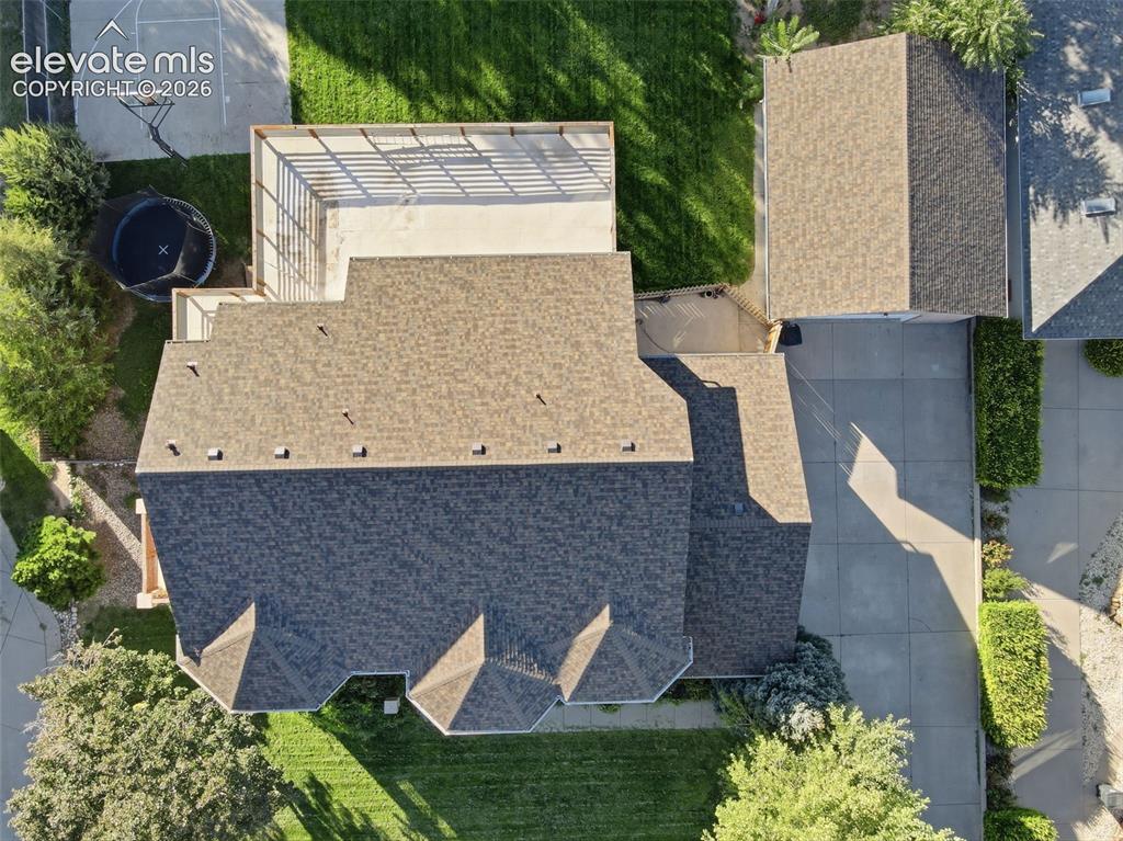 Image 44 of 49: Expansive property featuring a multi-gabled roofline, concrete driveway, lu