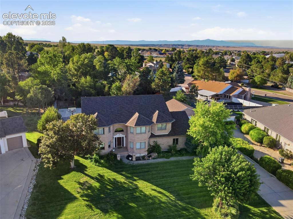 Image 45 of 49: Brick exterior residence with a multi-gabled roof and turrets