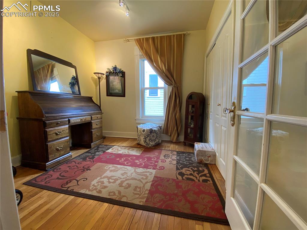 Image 11 of 36: The second bedroom features a beautiful French door