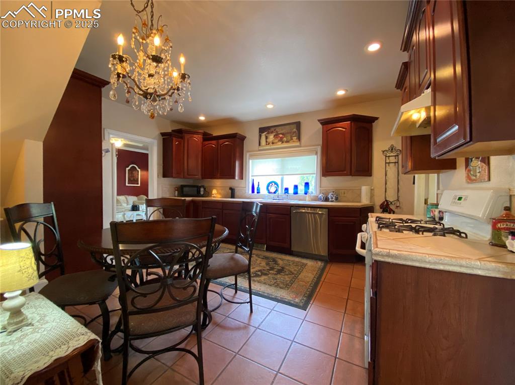 Image 14 of 36: With updated cabinetry, ceramic tile flooring