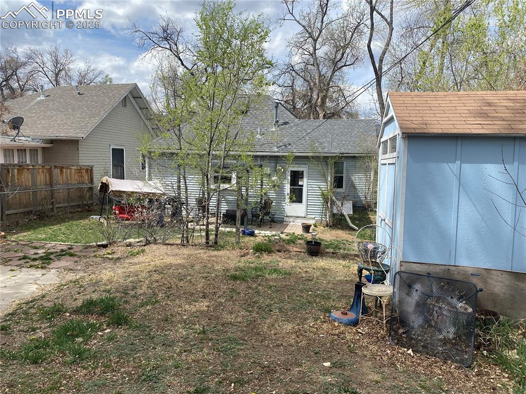 Image 28 of 36: A newer 8x10 shed provides storage for outdoor items