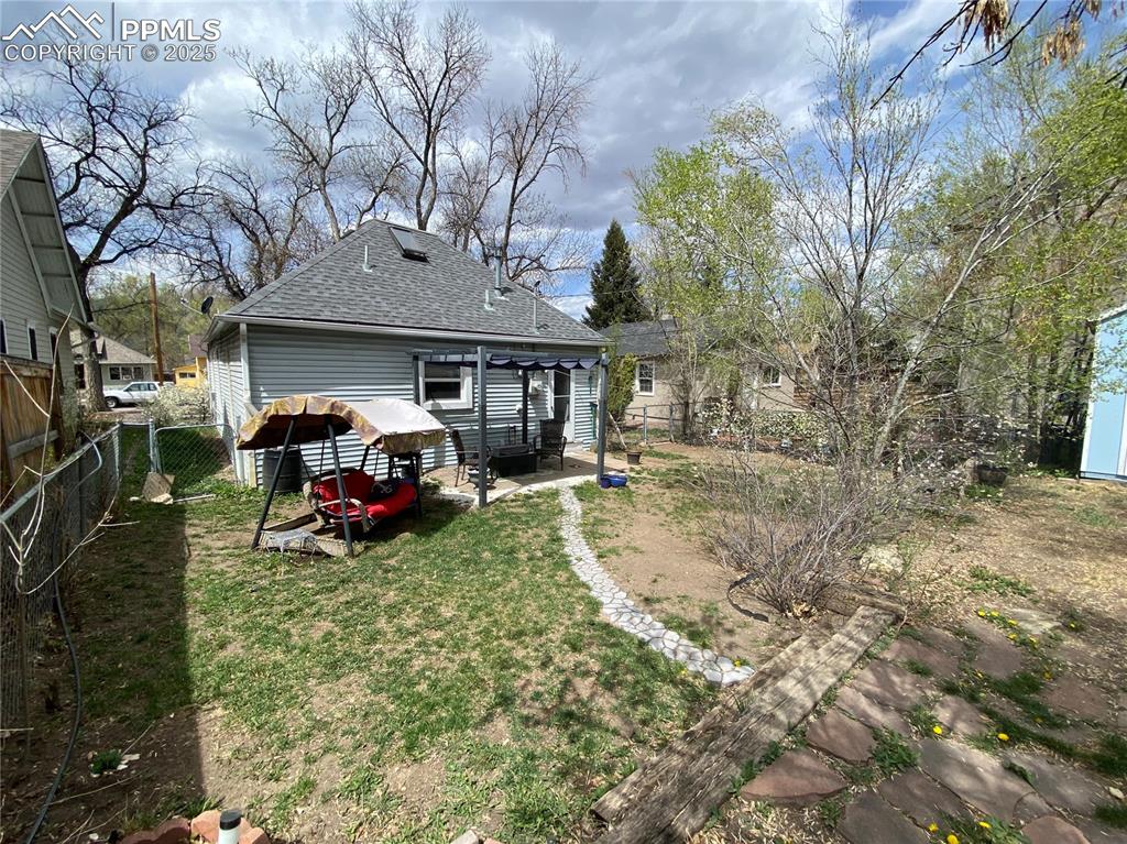 Image 29 of 36: The covered swing and pergola come with the home