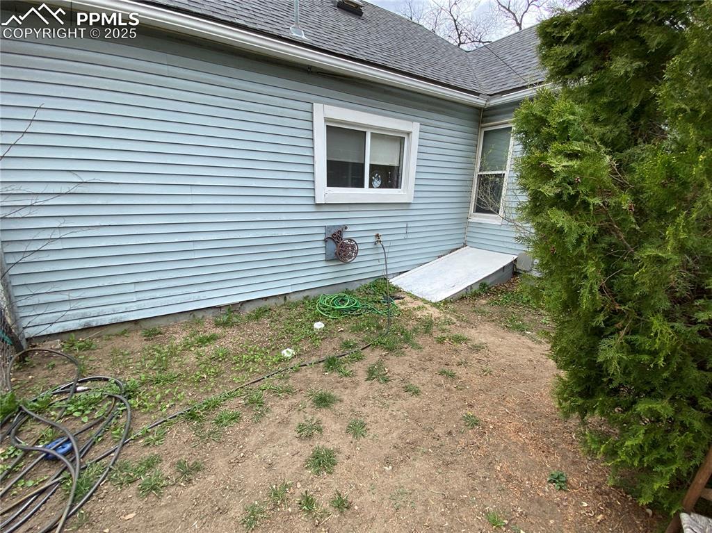 Image 31 of 36: The crawl space is accessible from the side yard