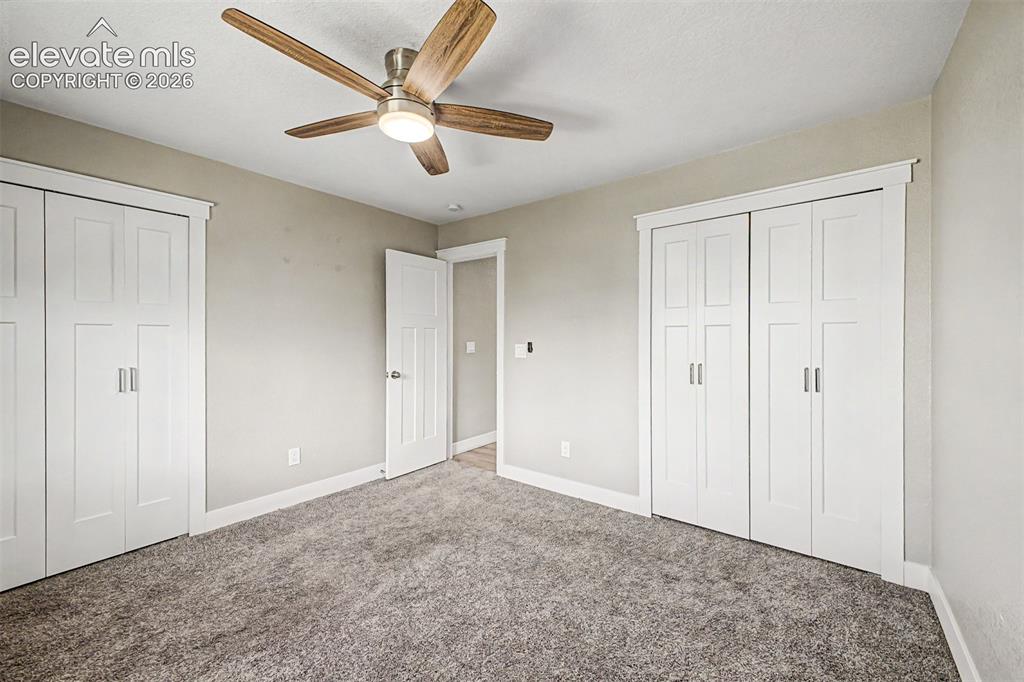 Image 17 of 31: Wood-finish ceiling fan with integrated lighting