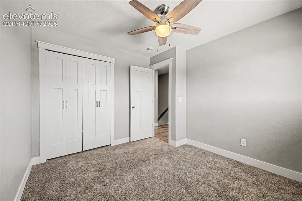 Image 20 of 31: Neutral wall tones, ceiling fan with integrated lighting, wood-finish bi-fo