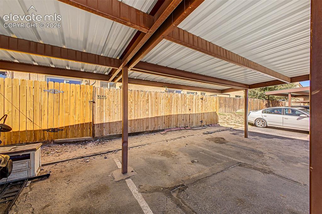 Image 26 of 31: Covered parking space with metal roofing and steel beam construction, featu