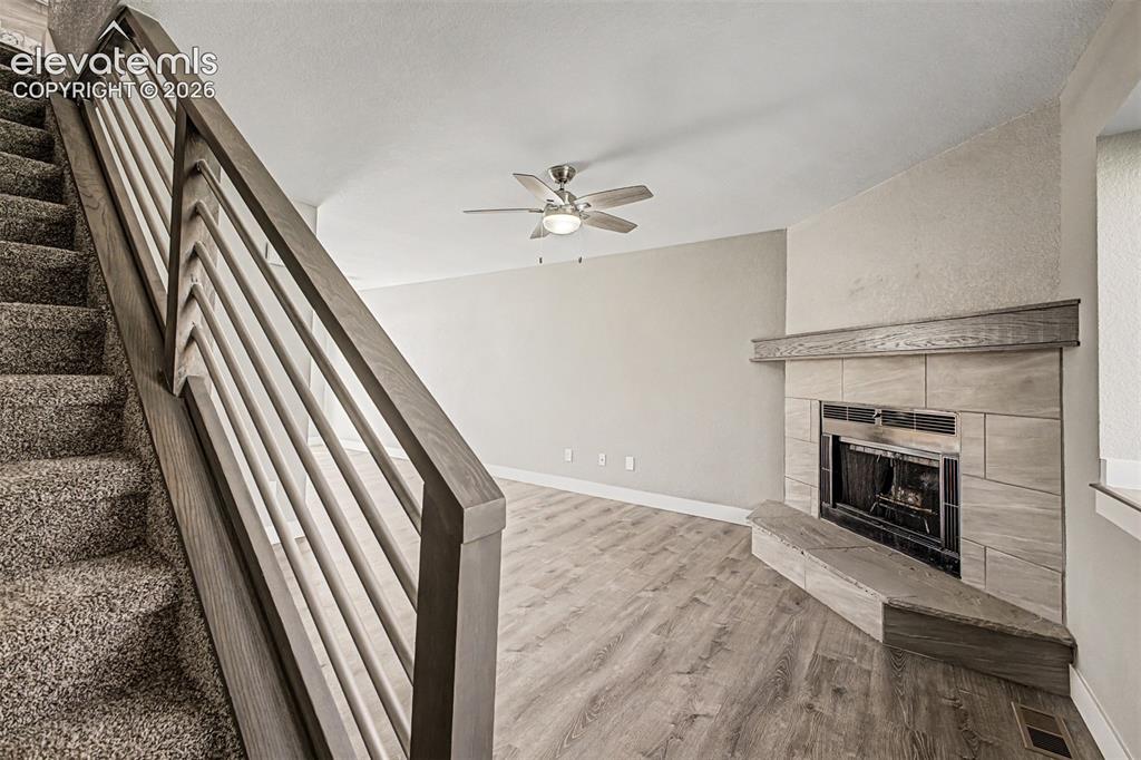 Image 5 of 31: Carpeted staircase with modern wood-finish railing, wood-finish flooring, f