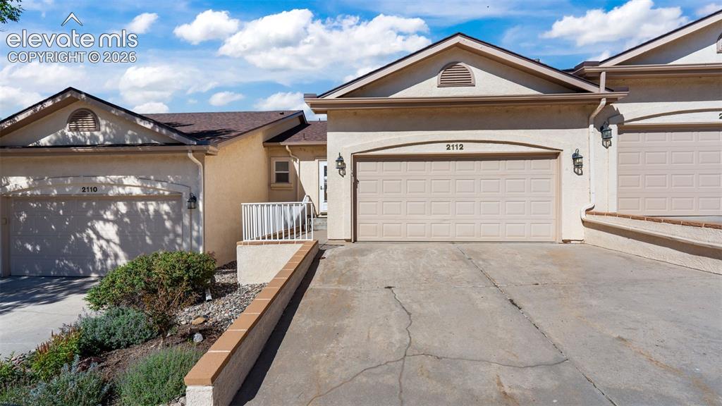 Caption: Lovely stucco exterior with finished 2 car garage