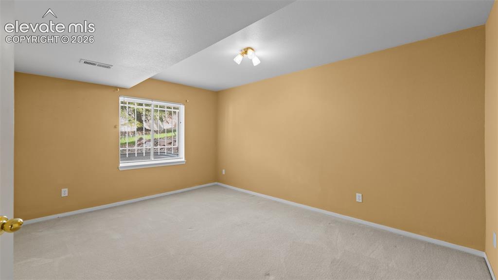 Image 22 of 28: Basement bedroom