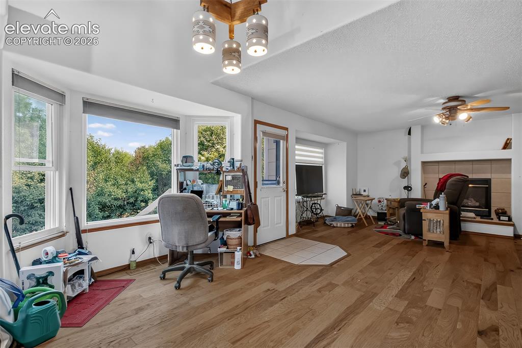 Image 11 of 41: Dinning area with Bay windows, hardwood floors and walk-out to west facing