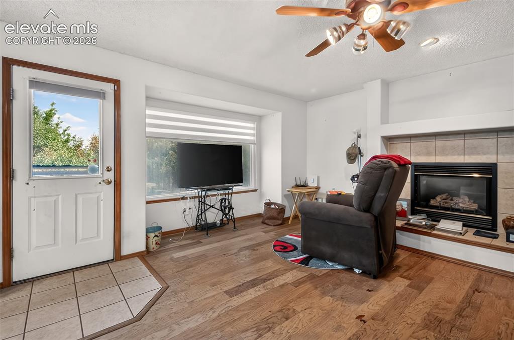 Image 13 of 41: Family Room with Fireplace and walk-out to recntly treated deck
