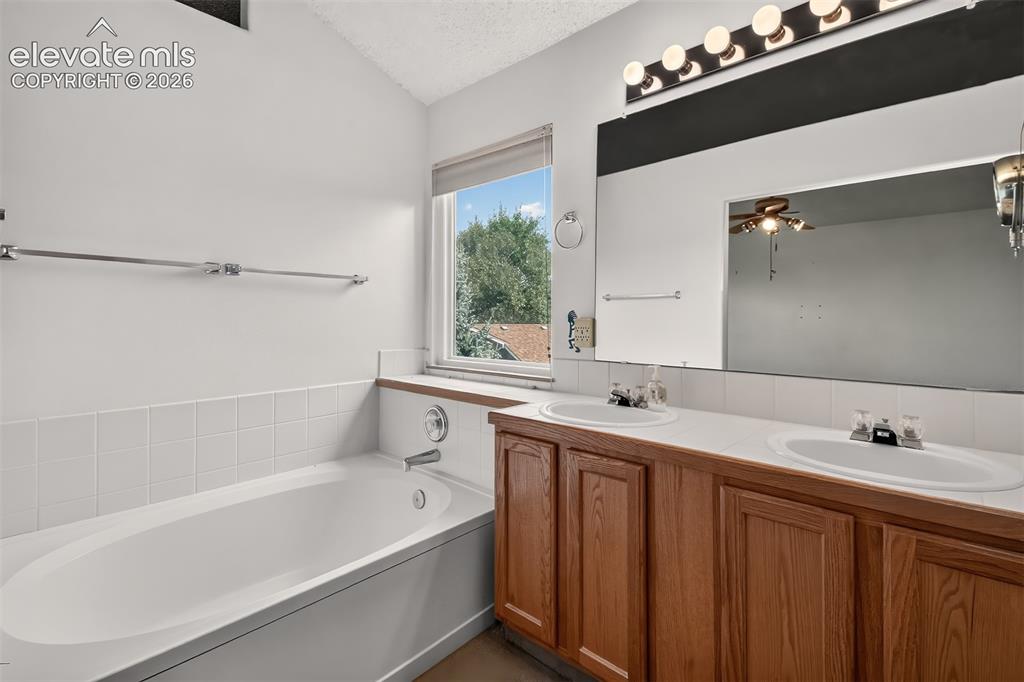 Image 18 of 41: Main Besroom Attached Bath with Soaking Tub and Double Vanity