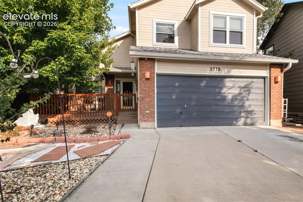 Image 2 of 41: Cleverly landscaped front yard has reduced maintenance.