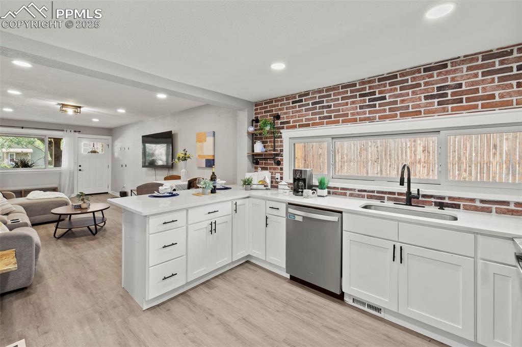 Image 9 of 27: Kitchen featuring open floor plan, healthy amount of natural light, brick w