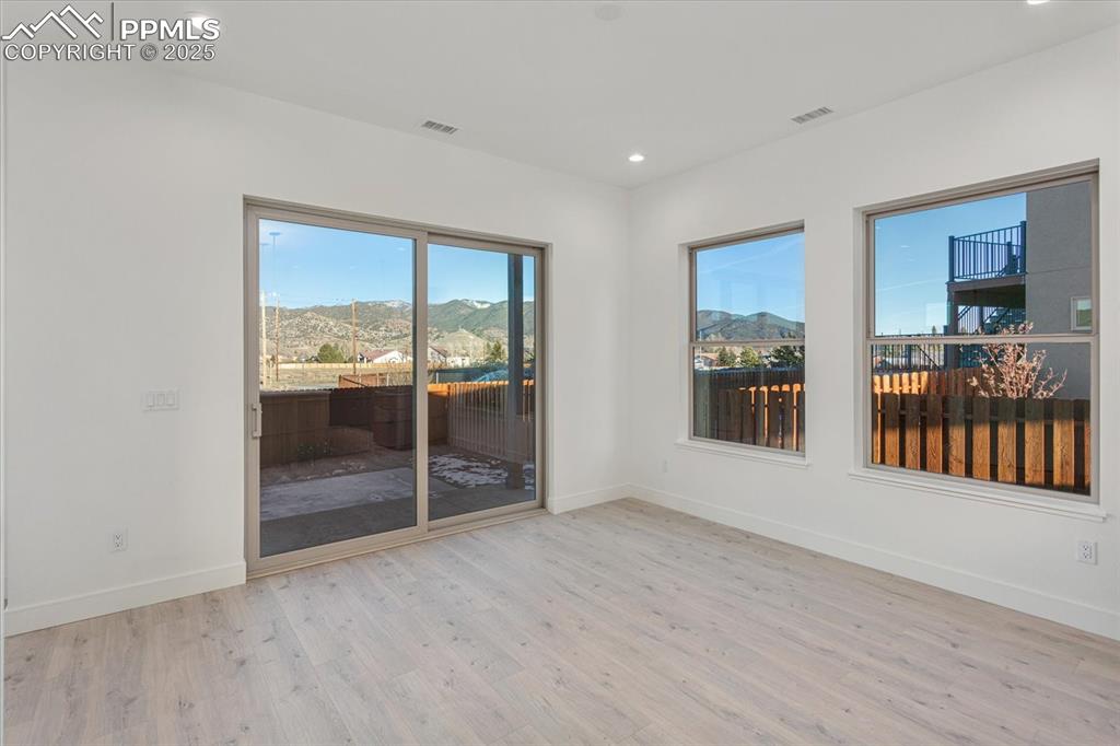 Image 10 of 30: Spare room with a mountain view and light hardwood / wood-style flooring