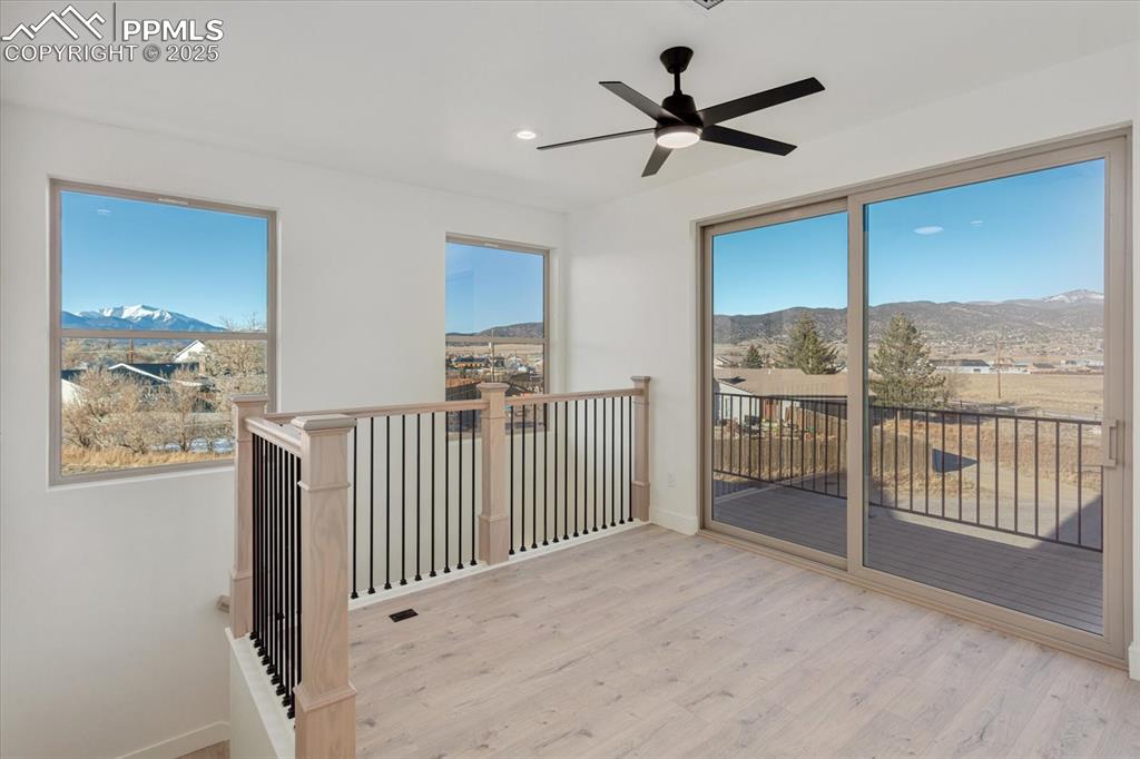 Image 13 of 30: Unfurnished sunroom with a mountain view and ceiling fan