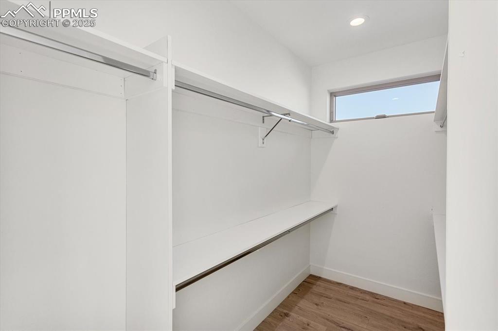 Image 16 of 30: Spacious closet featuring hardwood / wood-style floors