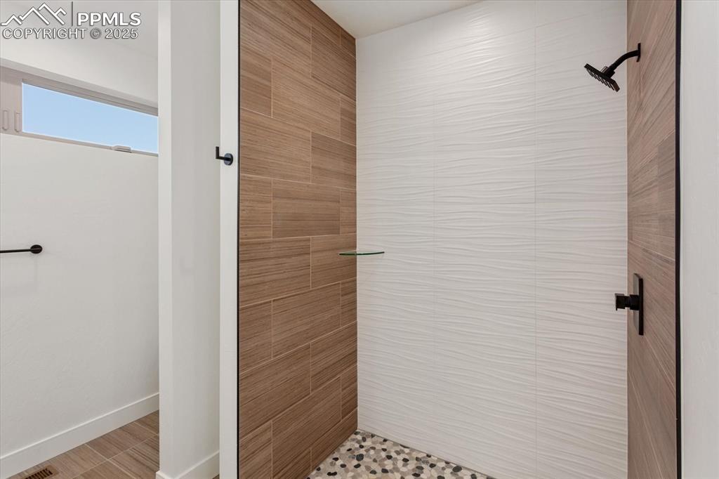 Image 17 of 30: Bathroom featuring a tile shower